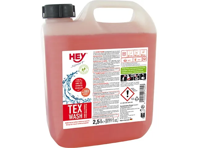 Eine rosafarbene 2500ml Flasche Tex Wash Spezialwaschmittel für Funktionsbekleidung mit schwarzem Deckel.