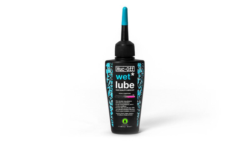 Muc-Off Wet Lube Schwarze Flasche Muc-Off Wet Lube mit blauem Applikator, Produkt für Fahrrad Kettenschmierung.