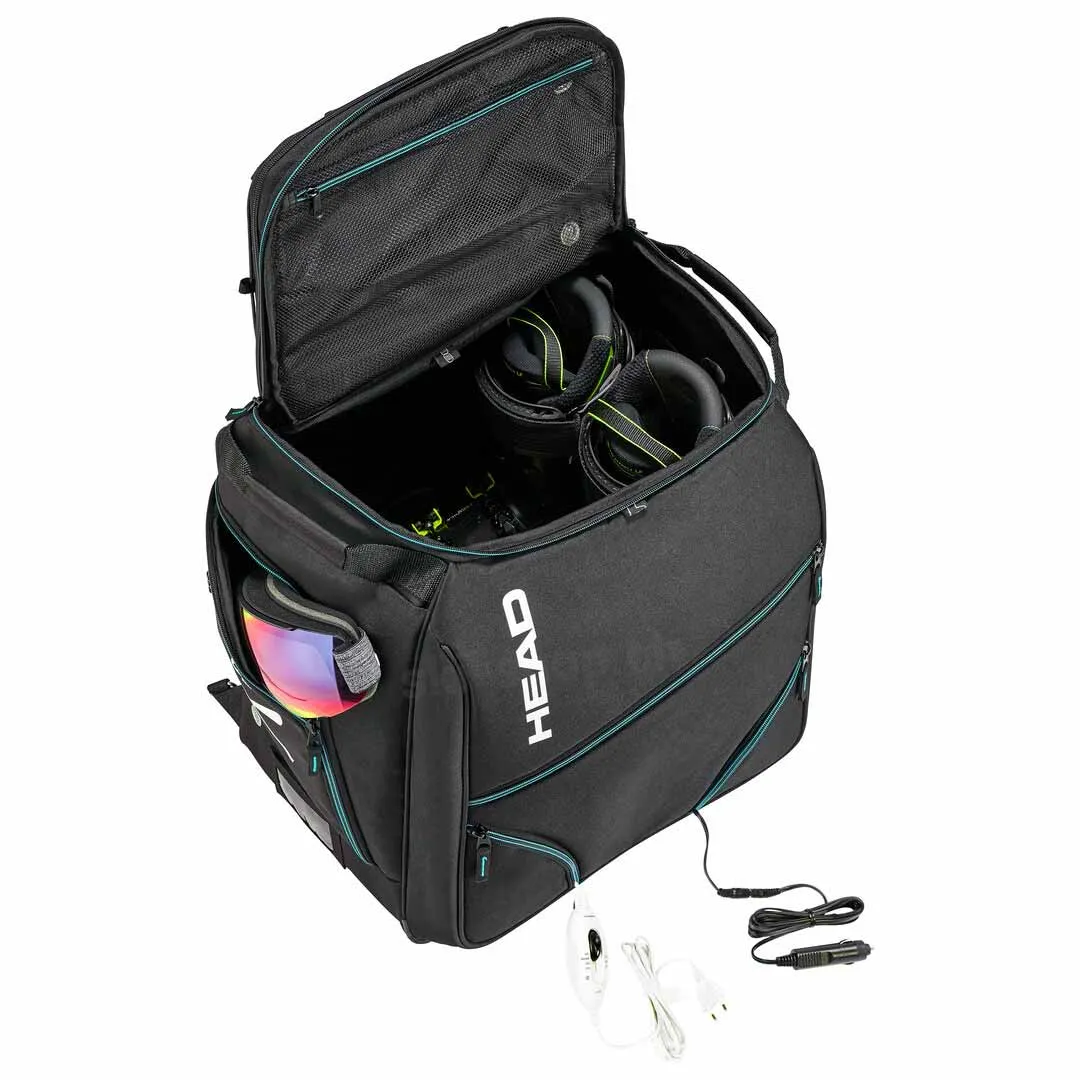 Geöffnete, schwarze Head Heatable Bootbag mit Skibrille und beheizbaren Skischuhen; Netzkabel sichtbar.