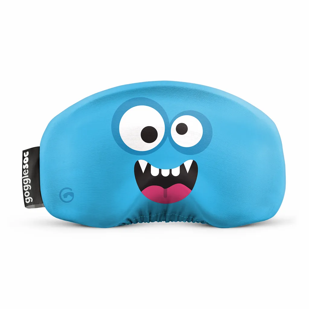 Blauer Monster Soc für Skibrille mit aufgedrucktem Gesicht mit großen Augen und Zähnen. Schwarzes Etikett mit weißem Schriftzug.