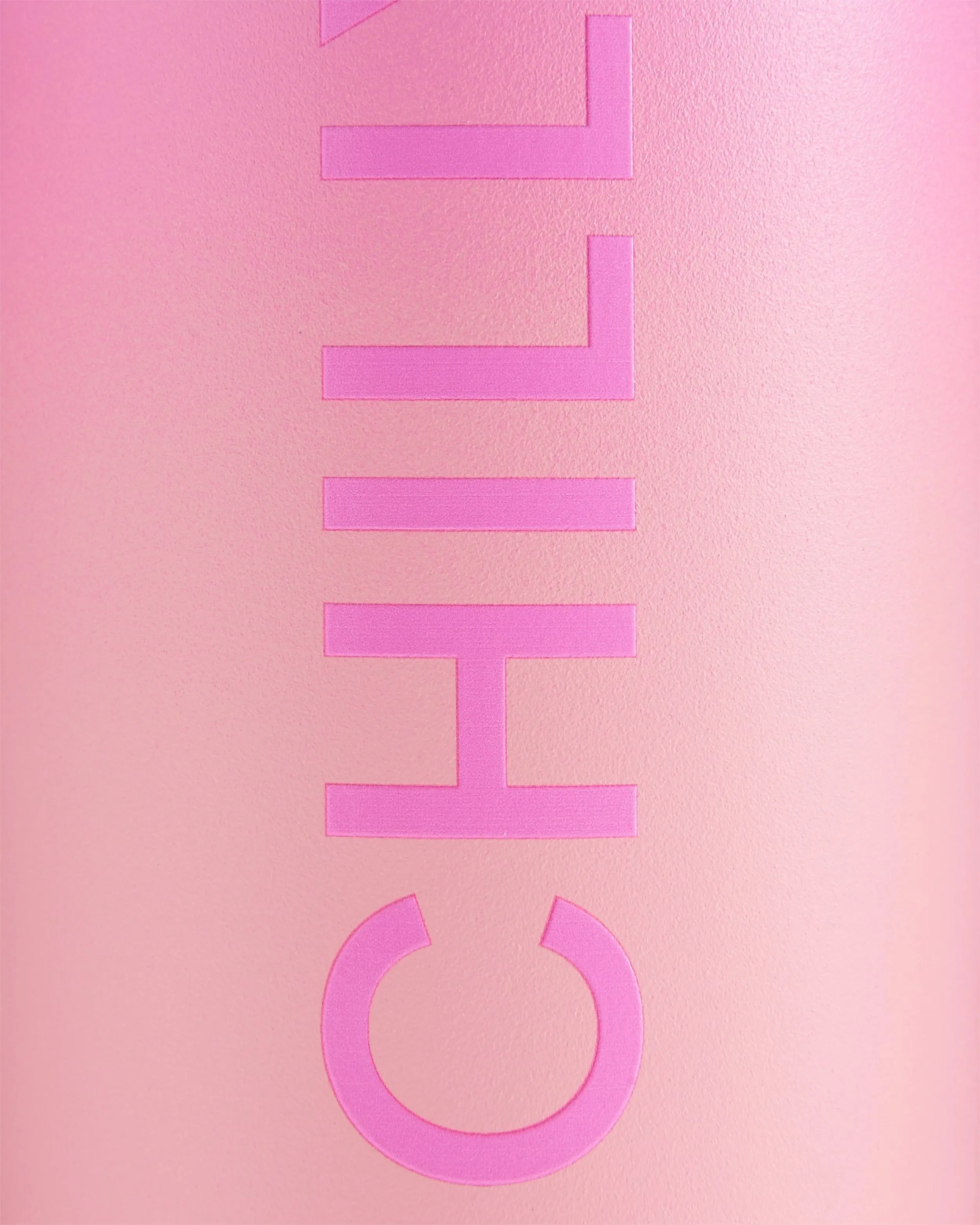 Nahaufnahme einer pinken Chillys Series 2 Flip Bottle mit erhabenem Logo auf pinkem Ombre-Hintergrund.