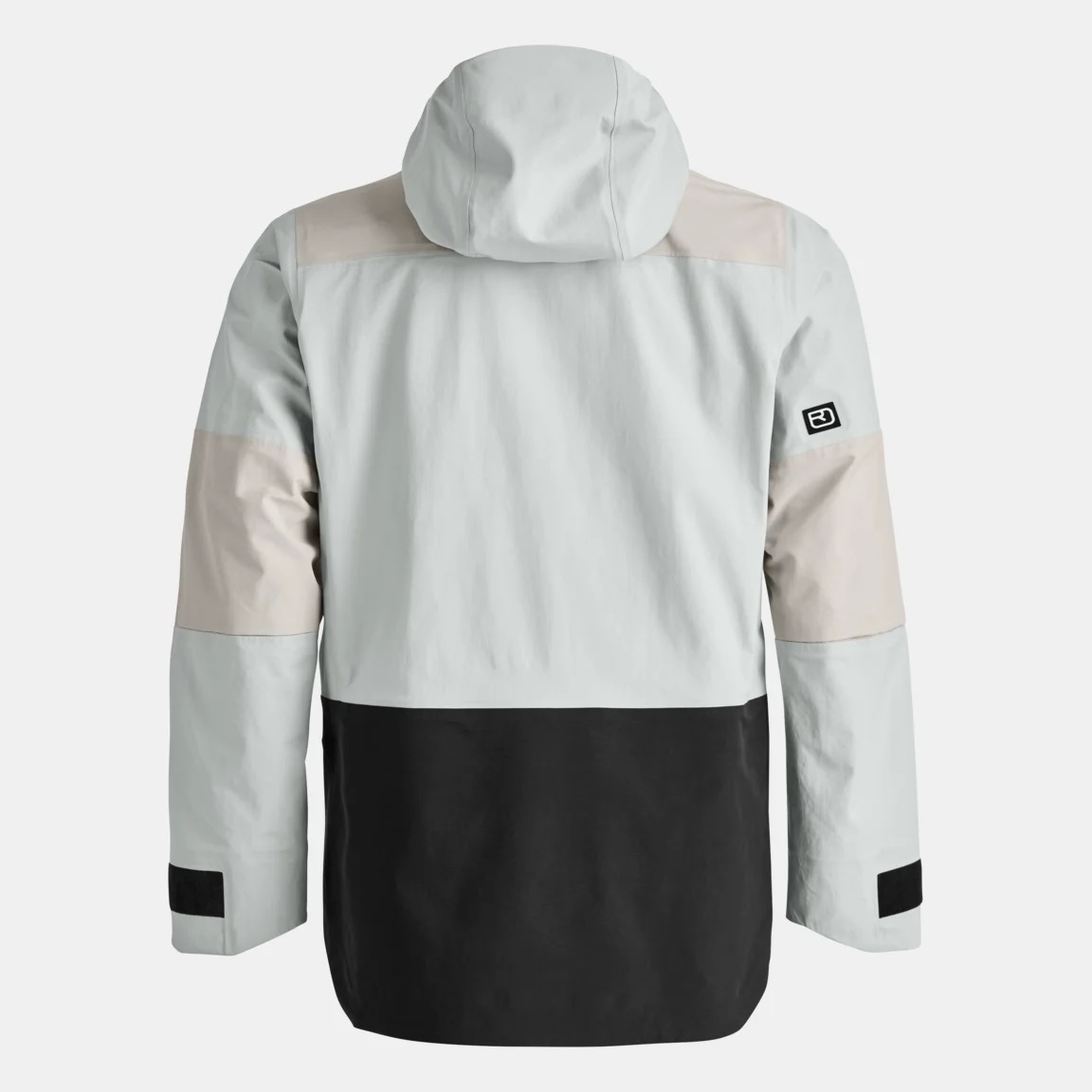 Rückansicht einer Winterjacke in Hellgrau, Beige und Schwarz mit Kapuze. Am linken Ärmel befindet sich ein kleiner, schwarzer Klettverschluss.