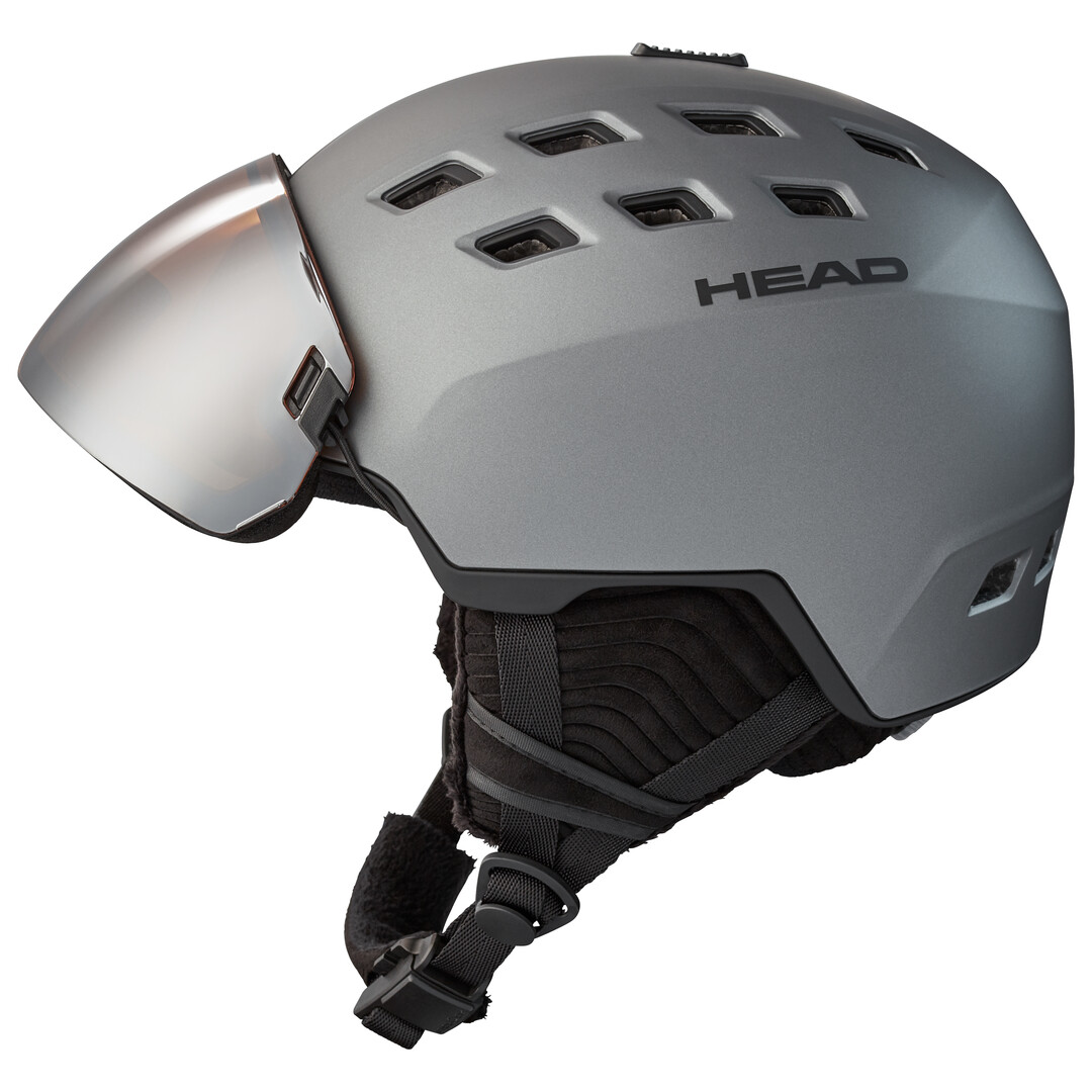 HEAD Radar Visierhelm – Innovation und Komfort für Skifahrer Grauer Skihelm mit Visier, mehreren Luftlöchern und Markenlogo "HEAD" seitlich. Kinngurt ist ebenfalls sichtbar.