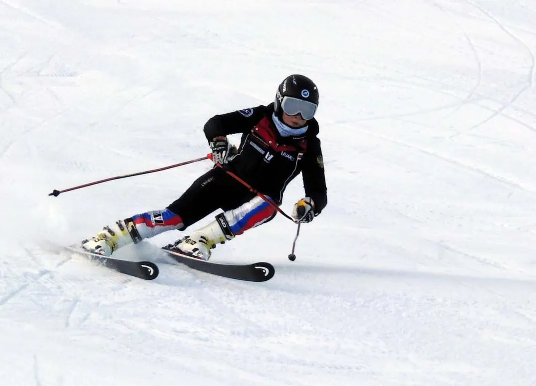 Skifahrer in Aktion auf Schnee, Ski Training, Fokus auf Körperposition und Skitechnik.