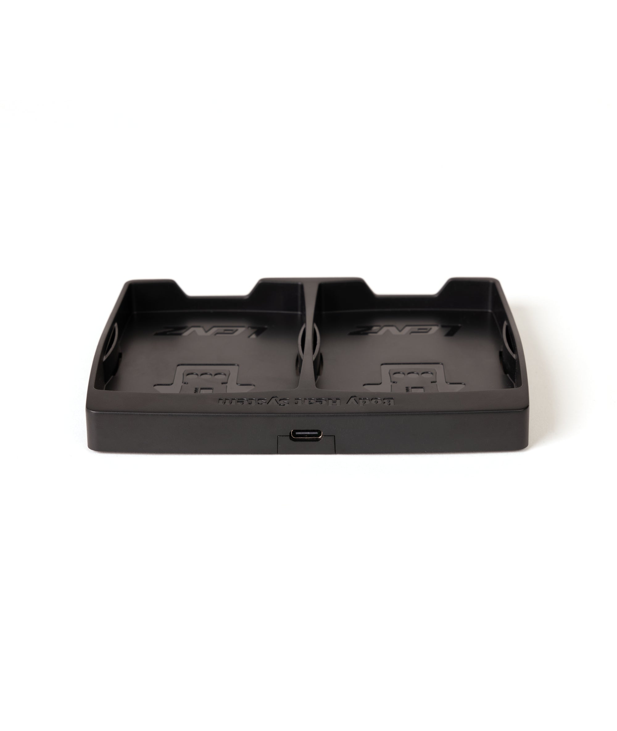 Schwarze Ladestation mit zwei Fächern und USB-C Anschluss auf einer weißen Oberfläche.