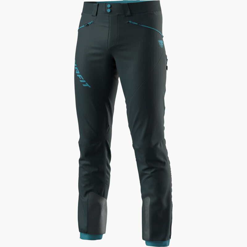 Dunkelblaue Dynafit TLT Hose Dunkelblaue Dynafit TLT Touring Hose für Herren mit hellblauen Akzenten auf weißem Hintergrund.