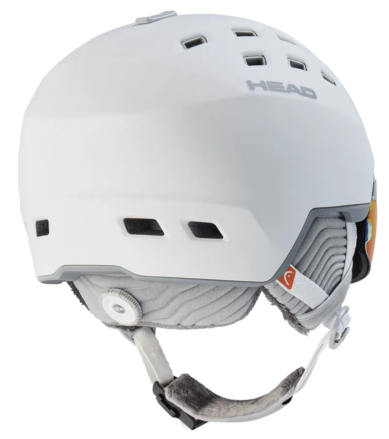 Weißer Skihelm "Head Rachel 5K Pola" mit integriertem Visier und Belüftungslöchern, seitliche Ohrenschützer und Kinnriemen.