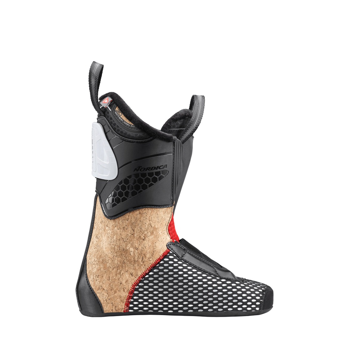 Innenschuh des Nordica Pro Machine 115 Women Skischuhs, Profilansicht. Schwarzer Schaft, Kork-Mittelteil und weiß gepunkteter Fußbereich.