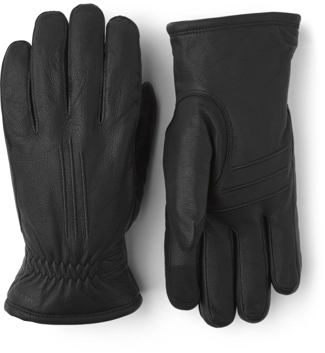 Zwei schwarze Lederhandschuhe liegen nebeneinander, einer mit der Handfläche nach oben, der andere mit dem Handrücken nach oben.