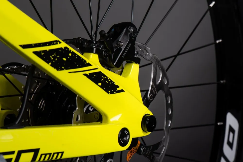 Nahaufnahme des gelben Hinterbaus eines Muret 2 EP8 E-Mountainbikes mit Shimano Bremse und Bremsscheibe.