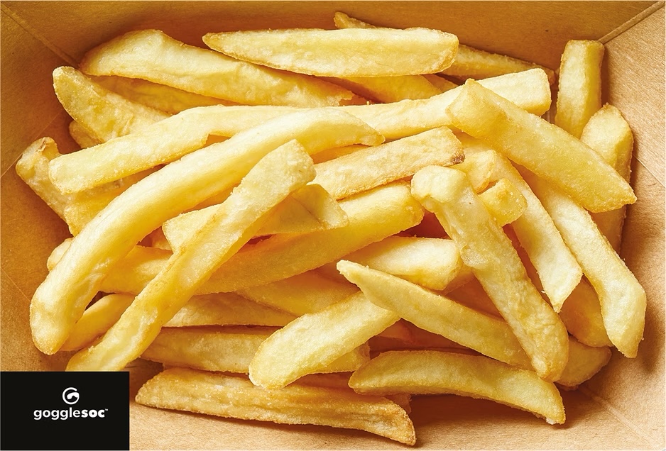 Goldgelbe Pommes Frites Nahaufnahme von goldgelben Pommes Frites in einer braunen Pappschale mit Logo.