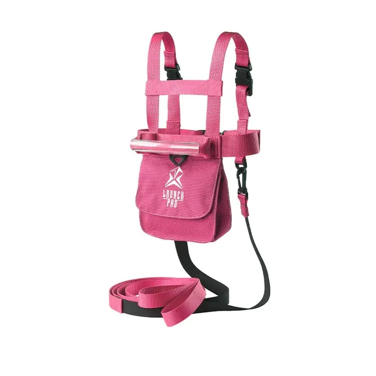 Pinkes Skigeschirr für Kleinkinder mit Haltegriff und abnehmbarer Leine. Verstellbare Schulter- und Taillengurte, Fronttasche mit 'LAUNCH PRO'-Logo und schwarze Schnallen. Leine aufgerollt für mehr Sicherheit.