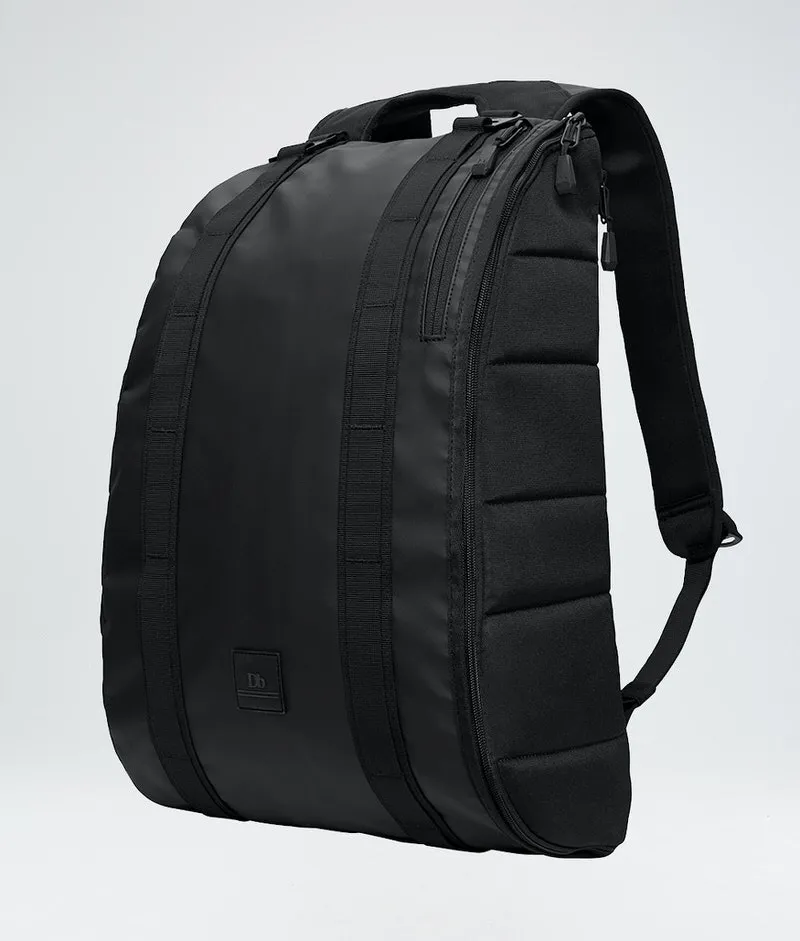 Schwarzer Douchebags The Base 15L Rucksack, seitliche Ansicht, Tragegriff und Schultergurte sichtbar.